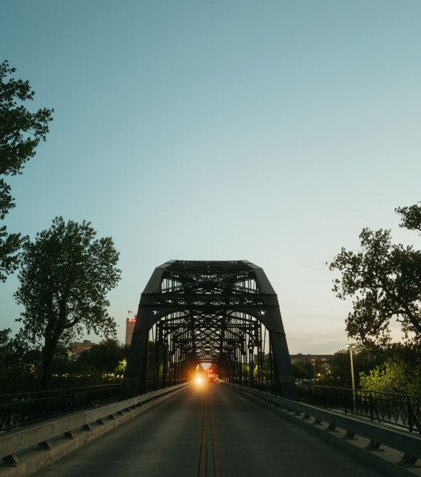 An street with view of old bridge during sunset