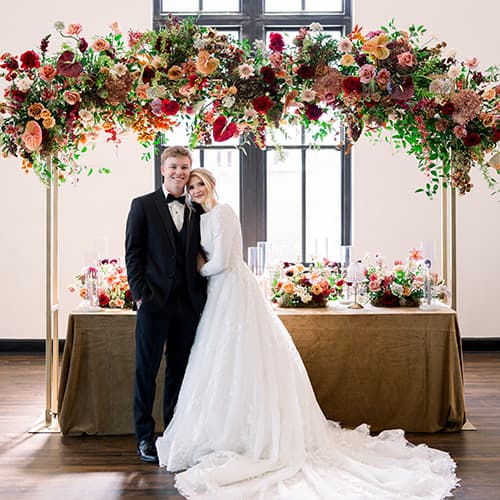 bride and groom in front of banquet table